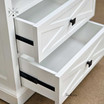 Angled front view with the drawers open displaying the metal drawer runners and storage space.