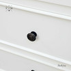 Close-up of top drawer knob detailing the elegant hardware.