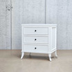 Angled view focusing on the bedside table's white finish