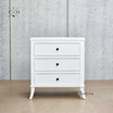 Front view of Piastri 3 Drawer Bedside Table showing the elegant white finish and sleek lines.