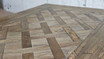 Top-down Detailed close-up perspective of the Bedford Oak Dining Table, highlighting its meticulous parquetry detail