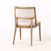 Three quarter rear view of the Argent Dining Chair showing the solid timber frame, tapered natural legs and upholstered back panel by Thomas & Hurley