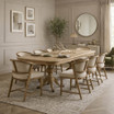Styled view of Windsor Chairs with an oak double extension table, by Thomas and Hurley.