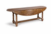Angled view of the Churchill Barley Twist Oval Drop Leaf Extending Table by Thomas and Hurley with leaves down, presenting a streamlined silhouette ideal for sophisticated transitional spaces and curated interior styling.