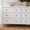 An detailed styled view of the Brynmore 6 Drawer Chest in White by Thomas and Hurley.