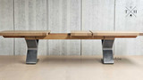 Experience luxury with Quinn's extendable table, featuring a sleek metal base and spacious design.
