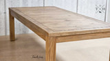 Low angle view of the entire table, emphasizing its grandeur and oak material