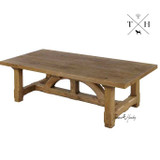 Angle view of the Trailbridge coffee table, emphasising the unique design of the bridge-style legs and the table's robust construction