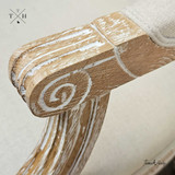 Zoomed-in view of the chair’s hand-carved accents, showcasing the artisan craftsmanship