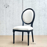 Diagonal angle capturing the unique balloon back design, a key feature of this French-style chair.