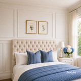 A diamond-tufted linen upholstered buttoned-back queen-size headboard shown from an angled view in a styled bedroom setting.
