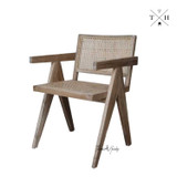 Side view of the Gallery Carver Chair, emphasizing the sleek lines and the unique oak finish.