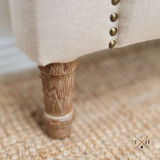 Close-up of one of the solid oak legs, emphasizing the craftsmanship and elegant cut-out design
