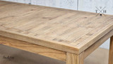 Detail of the table’s corner, emphasizing the slatted top and quality oak construction
