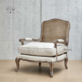 Angled perspective showing the overall design without the backrest cushion to showcase the Hamptons inspired rattan back