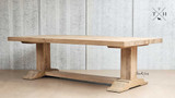 The silhouette of the Charlested Oak Dining Table in dim light, highlighting its strong lines and classic form