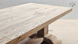 The Charlested Oak Dining Table under dim lighting, creating a cozy and intimate dining atmosphere