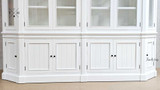 View of the cabinet's base, showcasing the solid construction and storage capacity with paneled doors.