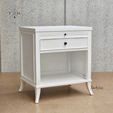 Angled view focusing on the bedside table's white finish