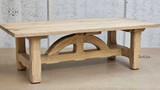 Angled close-up of the arch base of the Trailbridge Canyon Coffee Table, illustrating the fine woodworking details.