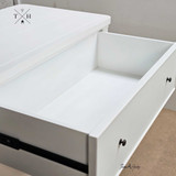 Close-up of the metal drawer runner highlighting the smooth operation and showcasing the hand-carved molding.