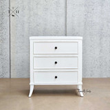 Front view of Piastri 3 Drawer Bedside Table showing the elegant white finish and sleek lines.