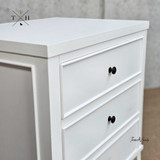 Close-up of drawer front of Piastri 3 Drawer Nightstand showcasing the hand-carved molding.