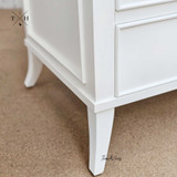 Close-up of leg design of the Piastri 3 Drawer Nightstand featuring the unique and stable construction.