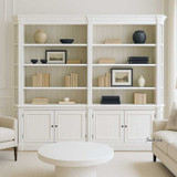 Front view of the Stonefield Double Bookcase Wall Unit with Angled Sides  in situ in a modern living room