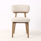 Front view of the Royston Dining Chair in premium neutral weave with natural timber frame by Thomas & Hurley, showcasing sculptural contemporary design