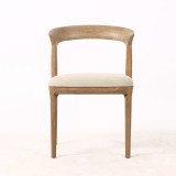 Laguna Dining Chair in natural timber finish, front view highlighting sculptural backrest and premium upholstered seat, a luxury contemporary dining chair for modern Hamptons interiors.