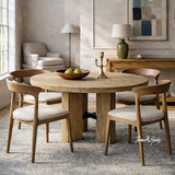 Styled view of the Tisbury Round 135cm Dining Table showcasing the architectural pedestal base and refined proportions.