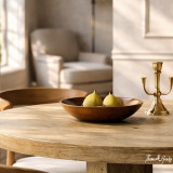 A close up view of the Tisbury Round 135cm Dining Table showcasing the timber top and finish.