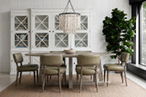 Ovalis 240cm Dining Table in brushed oak styled in a modern dining room with upholstered chairs