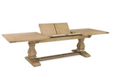 The Sandringham Double Extension Dining Table by Thomas & Hurley shown from a front angled perspective highlighting the sculptural pedestal base and contemporary Hamptons design, open with leaf extensions showing.
