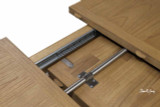 A detailed close up of the Sandringham Double Extension Dining Table photographed mid-extension revealing the functionality and workmanship of the durable extension mechanism.