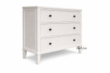A front angled view of the Lando 3 Drawer Chest in white showcasing streamlined design, a lightly tapered leg, and functional storage.