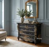 The Eloise 5 Drawer Chest in Black front angled styled view with French provincial detailing, intricate carving, and distressed antique finish.