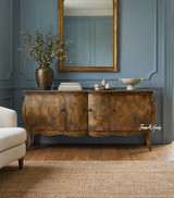 A front styled view of the Featherington Commode highlighting sculptural form,  hand-finished patina, and cabriole style legs.