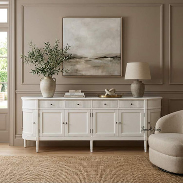 The Louis Buffet 250cm in White by Thomas and Hurley, front angle view and closed position, showcasing its curved design, fluted drawer detailing, and functional storage.