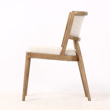 Side profile of the Argent Dining Chair featuring textured upholstery and natural wood legs, a contemporary dining chair ideal for Hamptons dining tables.