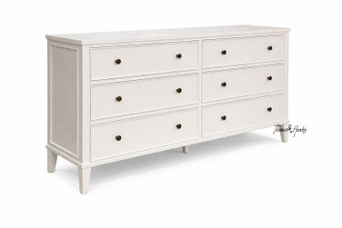 A front angled view of the Lando 6 Drawer Chest in white showcasing streamlined design, a lightly tapered leg, and functional storage.