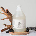 Amenie Salon lavender body wash gallon bottle with spa stones and wood decor