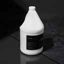 Amenie Sicilian Tangerine Lotion gallon bottle with dramatic side lighting on a dark background