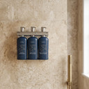 Triple shower dispenser with Voyager shampoo, conditioner and body wash bottles