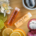 PAYA travel-size shampoo and conditioner arranged on wooden board