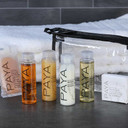 Six PAYA travel bottles and bars individually set out in a neat row on countertop