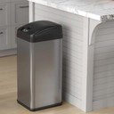 Sleek stainless steel trash can placed in a modern hotel room corner