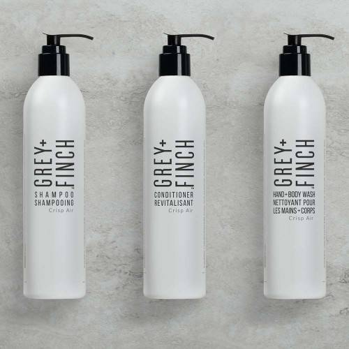 Citrus-scented DoveLok Shampoo, Conditioner, and Body Wash by Grey + Finch in guest bottles