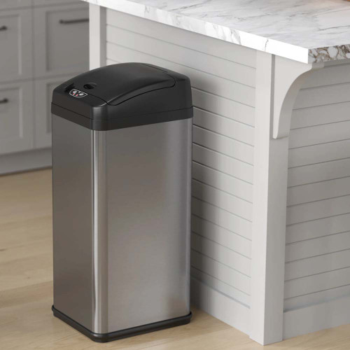 Sleek stainless steel trash can placed in a modern hotel room corner